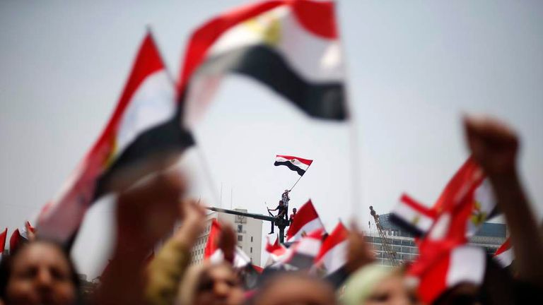 Protesters, who are against Egyptian President Mohamed Mursi, wave flags in Tahrir Square in Cairo