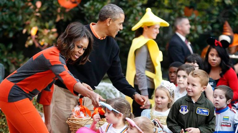 Obama and first lady give Halloween treats to visiting children at the White House in Washington