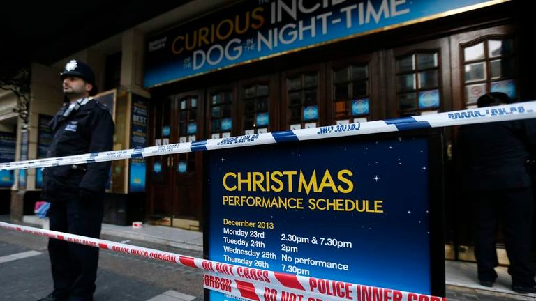 Police officers stand on duty outside the Apollo theatre on the morning after part of it's ceiling collapsed on spectators as they watched a performance, in central London