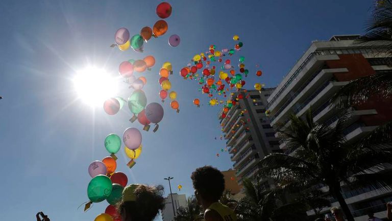 Demonstrators release balloons with messages against Russia's President Vladimir Putin and anti-gay laws, ahead of the Sochi 2014 Olympic Games, in Rio de Janeiro