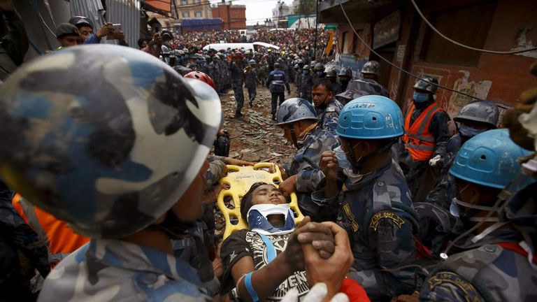 Earthquake survivor Pema Lama is rescued by the Armed Police Force from the collapsed Hilton Hotel six days after Saturday's earthquake, in Kathmandu