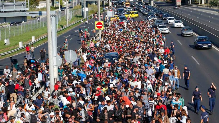 Migrants march along highway out of Budapest for the border with Austria