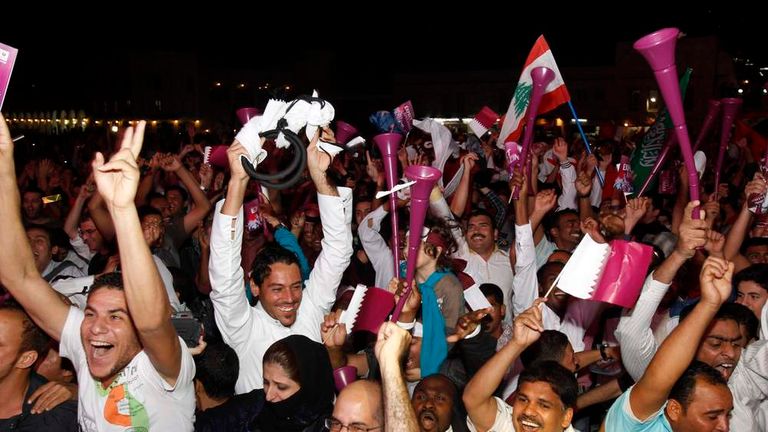 People celebrate after Fifa announce that Qatar will be host of the 2022 World Cup in Souq Wakif in Doha