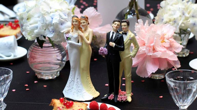 Same-sex couple plastic figurines are displayed during a gay wedding fair in Paris