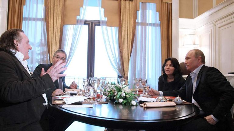 French actor Gerard Depardieu, left, speaks to President Vladimir Putin and unidentified aides