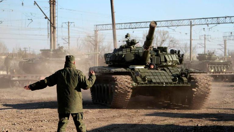 A Russian serviceman directs Russian tanks after their arrival in Crimea in the settlement of Gvardeiskoye near the Crimean city of Simferopol