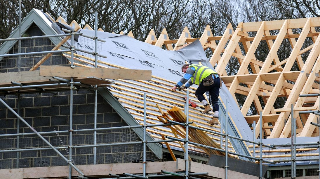 A roof worker building new houses. File picture