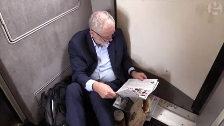 Jeremy Corbyn sits on the floor of a train