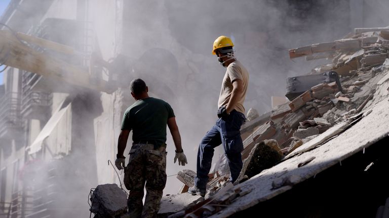 Volunteers work to move rubble and debris during search and rescue operations in Amatrice, central Italy, following an earthquake