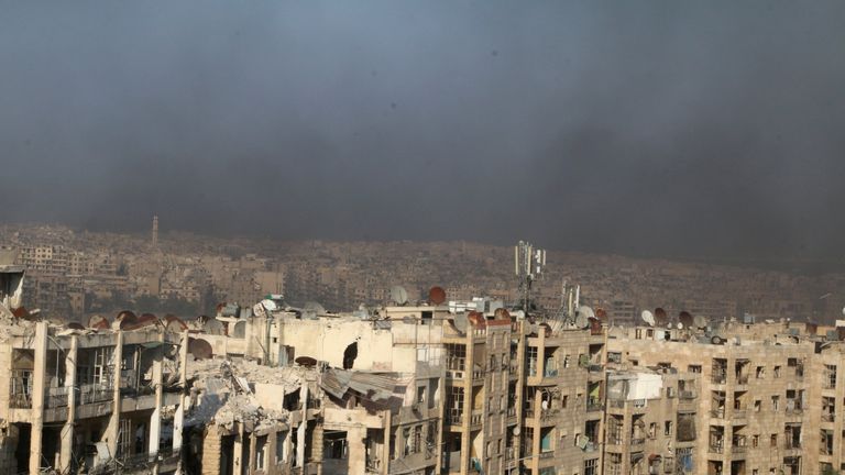 A general view shows rising smoke from burning tyres, which activists said are used to create smoke cover from warplanes, in Aleppo