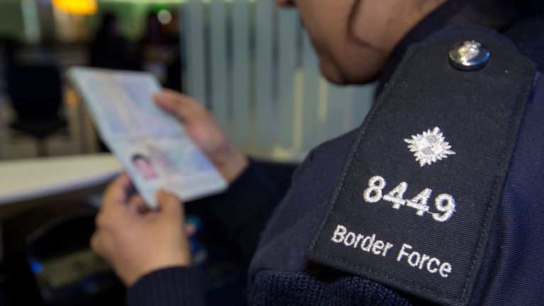 A UK Border Force officer checking passports. File picture
