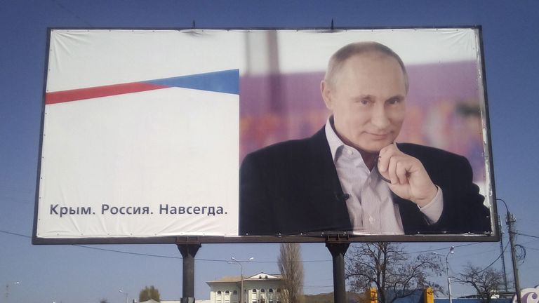 Putin on a board in Kerch, Crimea. The sign says: "Crimea. Russia. Forever."