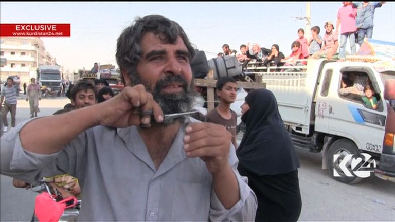 Manbij resident cuts his beard after the city is liberated from Islamic State