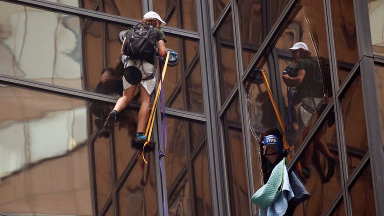 NYPD officers try to detain a man climbing the outside of Trump Tower