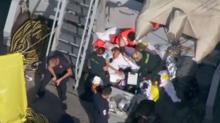Footage from the Sky News helicopter shows two of the suspected migrants being treated by paramedics