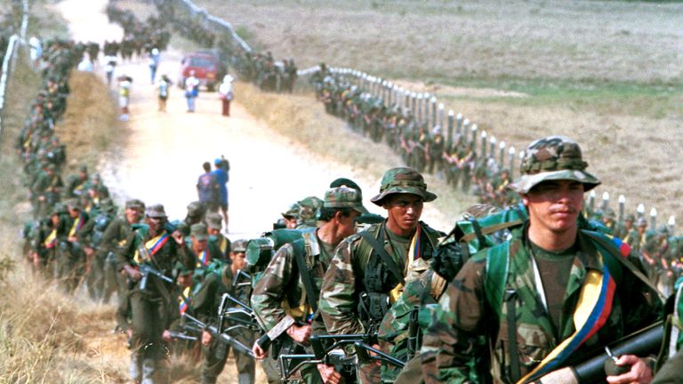 FARC rebels patrol a road in 1999