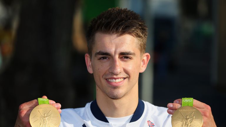 Max Whitlock holds up his two gold medals.