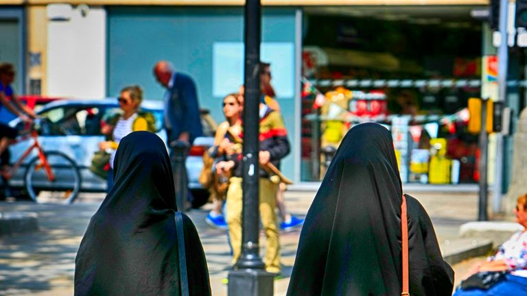 Two Muslim women in burkas walking in Bristol 