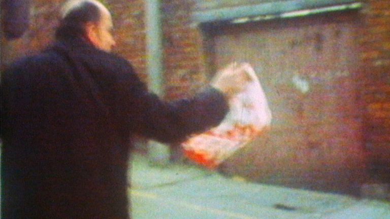 Edward Daly leads an injured man to safety