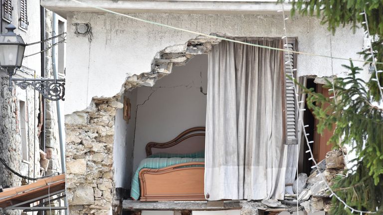 The wall has crumbled in the side of a house in the quake