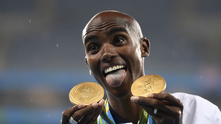 Britain's Mo Farah celebrates with his two gold medals from Rio 2016