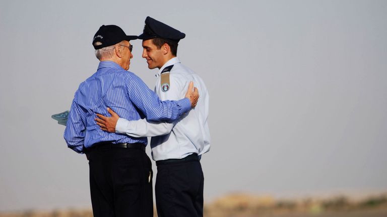 Asaf Ramon, son of Israel&#39;s first astronaut Ilan Ramon who died when space shuttle Columbia crashed in 2003, is greeted by Peres during a ceremony when he was awarded his air force pilot wings on June 25, 2009