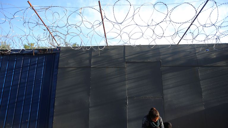 A refugee woman on Hungary&#39;s fortified border with Serbia