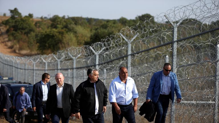 Hungarian Prime Minister Viktor Orban (centre L) and his Bulgarian counterpart Boiko Borisov (centre R) inspect the barbed wire fence on the Bulgaria/Turkish border