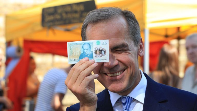 Bank of England governor Mark Carney with a new £5 note as London&#39;s Whitecross Street market