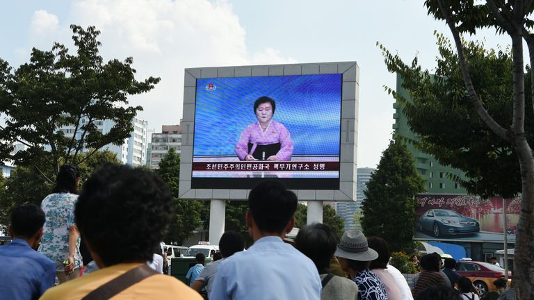 A big screen at Pyongyang railway station shows presenter Ri Chun-Hee announcing the test