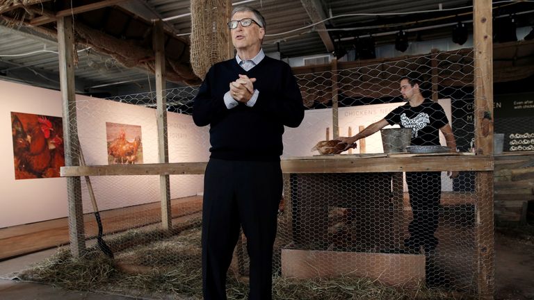 Bill Gates stands in front of a chicken coop in New York, where he pledged to donate 100,000 chicks to developing countries