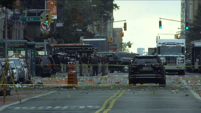 Debris and evidence litters the street as the sun rises over Manhattan
