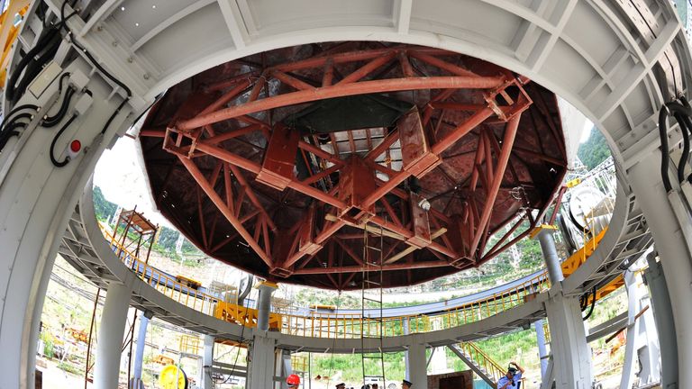 Engineers work on the colossal telescope in July 2015