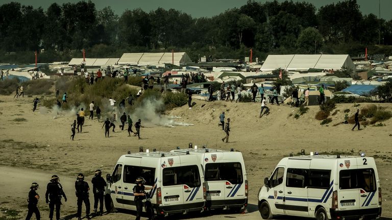 Riot police disperse migrants who were trying to get into trucks heading to Great Britain, on September 21, 2016 in Calais. / AFP / PHILIPPE HUGUEN (Photo credit should read PHILIPPE HUGUEN/AFP/Getty Images)