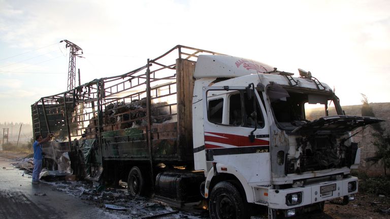 A damaged truck carrying aid is seen on the side of the road in the town of Orum al-Kubra on the western outskirts of the northern Syrian city of Aleppo