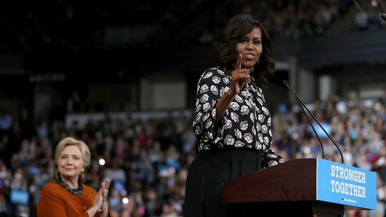 WINSTON-SALEM, NC - OCTOBER 27: Democratic presidential nominee former Secretary of State Hillary Clinton (L) looks on as First Lady Michelle Obama speaks during a campaign rally at Wake Forest University on October 27, 2016 in Winston-Salem, North Carolina. With less than two weeks to go before the election, Hillary Clinton is campaigning in North Carolina with First Lady Michelle Obama. (Photo by Justin Sullivan/Getty Images)