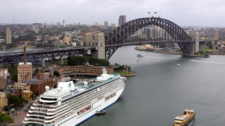 SYDNEY, AUSTRALIA: The cruise liner &#39;Crystal Serenity&#39; sits berthed at Sydney&#39;s historic Rocks area (L), 17 February 2005, with the Harbour Bridge (top). Australia&#39;s biggest sporting, entertainment and cultural festival, &#39;Easter in Sydney&#39;, now in its second year and taking place over two weeks next month between 17 March and 03 April, is anticipated to bring in an extra 30,000 visitors to explore the city. AFP PHOTO/Greg WOOD (Photo credit should read GREG WOOD/AFP/Getty Images)