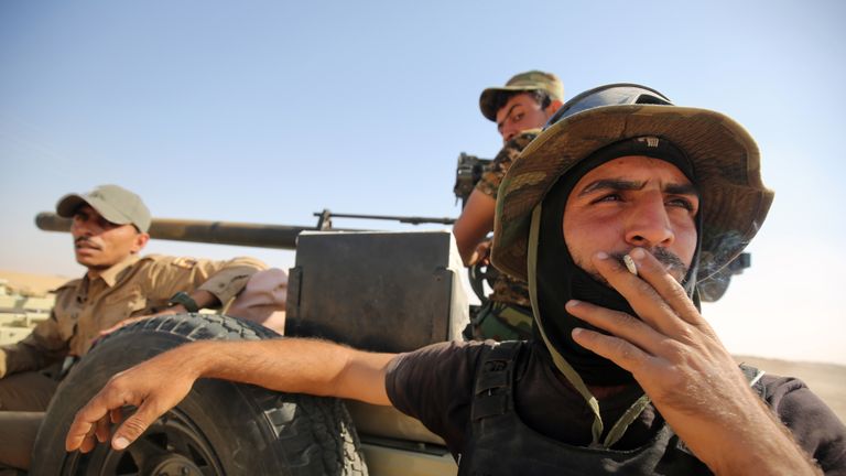 Shiite fighters from the Popular Mobilization Forces arrive in an area south of Mosul