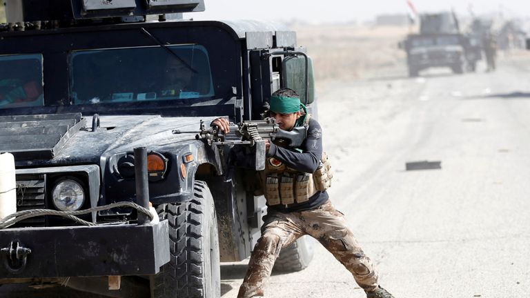 An Iraqi special forces soldier fires a rifle during clashes with Islamic States fighters in Bartella