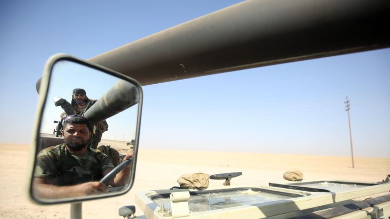 Shia fighters from the Popular Mobilization Forces arrive in an area south of Mosul