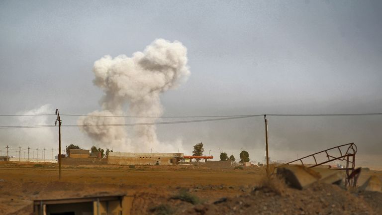 Smoke billows as Iraqi forces deploy in the area of al-Shurah