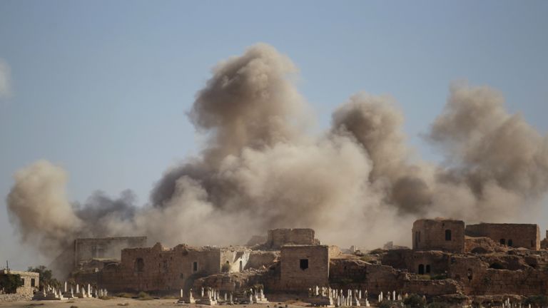 Smoke rises behind the ancient castle of the rebel-controlled town of Maaret al-Numan after airstrikes in Idlib province, Syria, September 25,
