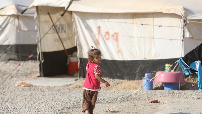 A displaced child who fled Islamic State militants from Mosul plays at Deepaka camp in the northwest of Erbil