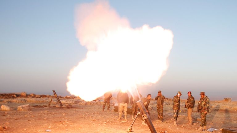 Peshmerga forces fire a mortar towards Islamic state militants' positions in the town of Naweran near Mosul