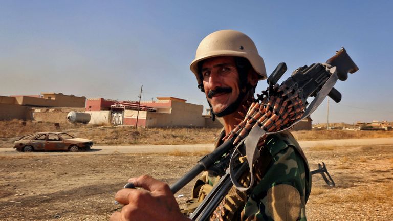 An Iraqi Kurdish Peshmerga fighter looks on in Nawran village