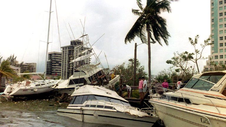 MIAMI, FL - AUGUST 24: Wrecked boats sit on the sea wall 24 August 1992 at the docks at Dinner Key in the Coconut Grove area of the city after Hurricane Andrew passed through southern Florida. Andrew was the strongest hurricane to hit southern Florida in 40 years. (Photo credit should read ROBERT SULLIVAN/AFP/Getty Images)