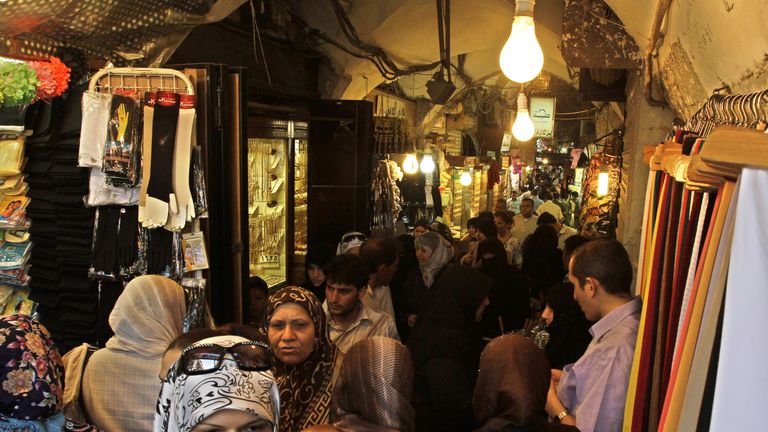 People shop at the main market, or souk, in the Syrian city of Aleppo June 23, 2010. 