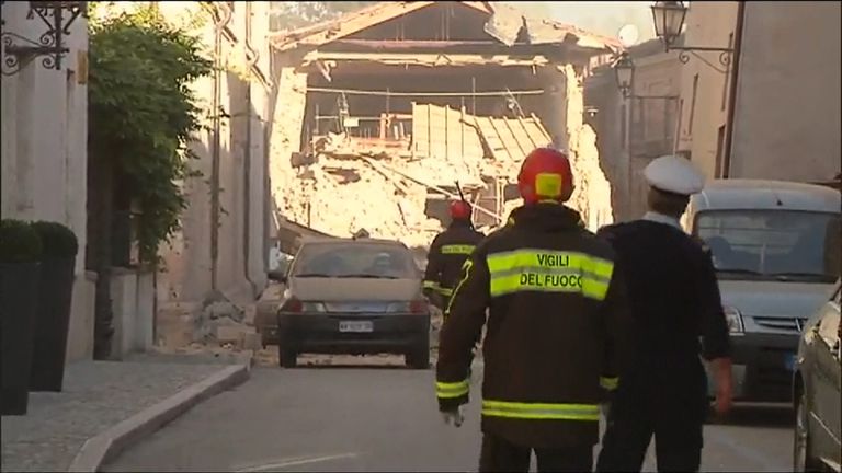 Rescue workers survey the damage to buildings