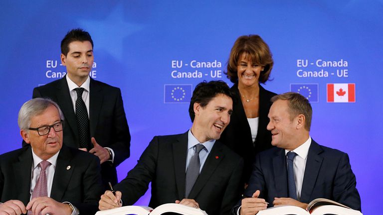 From left: Mr Juncker, Mr Trudeau and Mr Tusk sign the deal