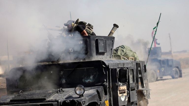 An Iraqi special forces soldier fires a cannon at Islamic States fighters in Bartella